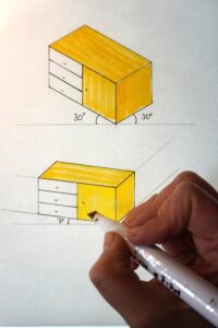 Eine Hand hält einen Marker und illustriert damit eine von unten beleuchtete Möbelskizze.